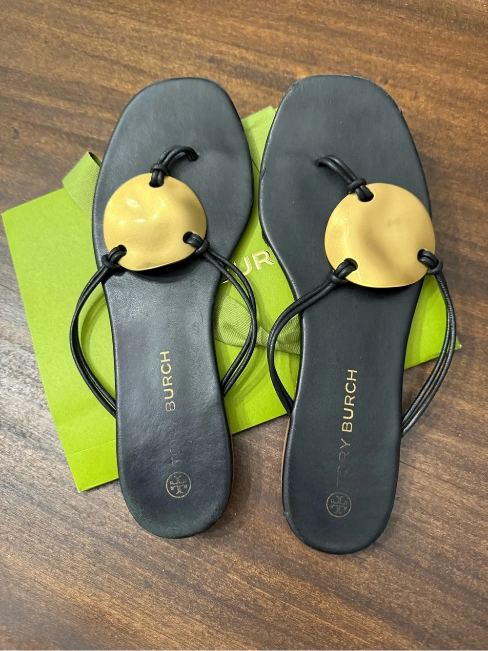 Tory Burch Patos Disk Leather Thong Sandals in black with gold-tone medallions